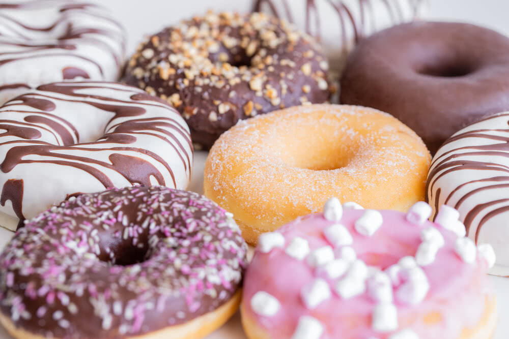 Donuts with assorted toppings like chocolate and sprinkles.