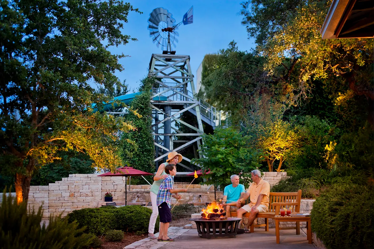 Family making s'mores around the fire pit at Hyatt Vacation Club at Wild Oak Ranch, San Antonio, Texas