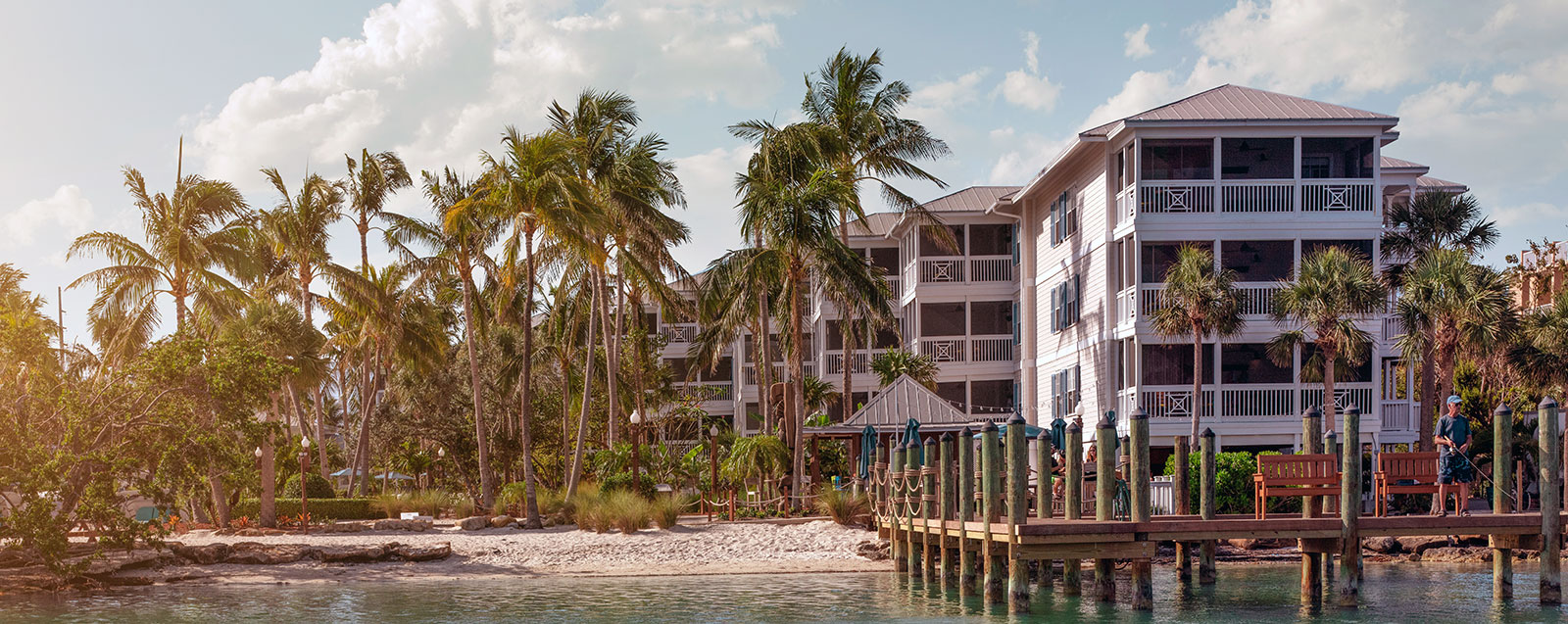 Poolside view with palm trees and ocean at a Key West resort