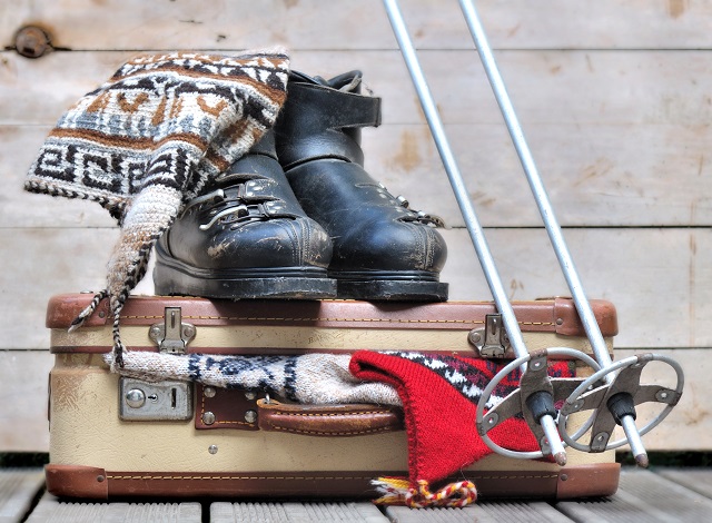Old,Ski,Boots,On,A,Small,Suitcase,Full,Of,Warm