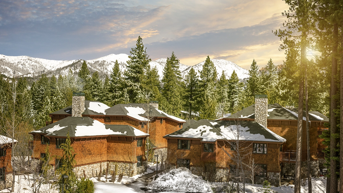 The Lake Tahoe High Sierra Lodge sits under the sun at the foot of snow capped mountains