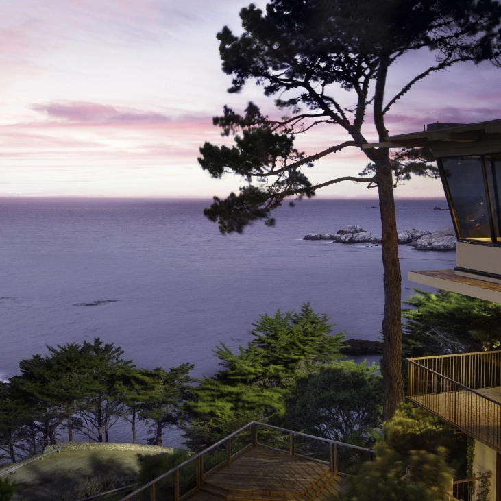 An outdoor patio overlooks a calm ocean