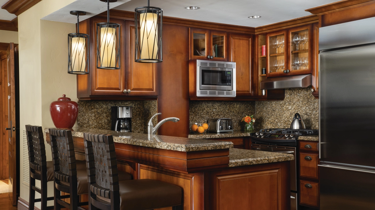 A range, refrigerator, microwave, and coffee maker make up a fully equipped kitchen