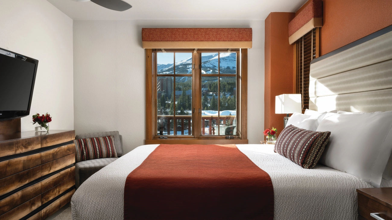 View of villa bedroom with rustic wood accents