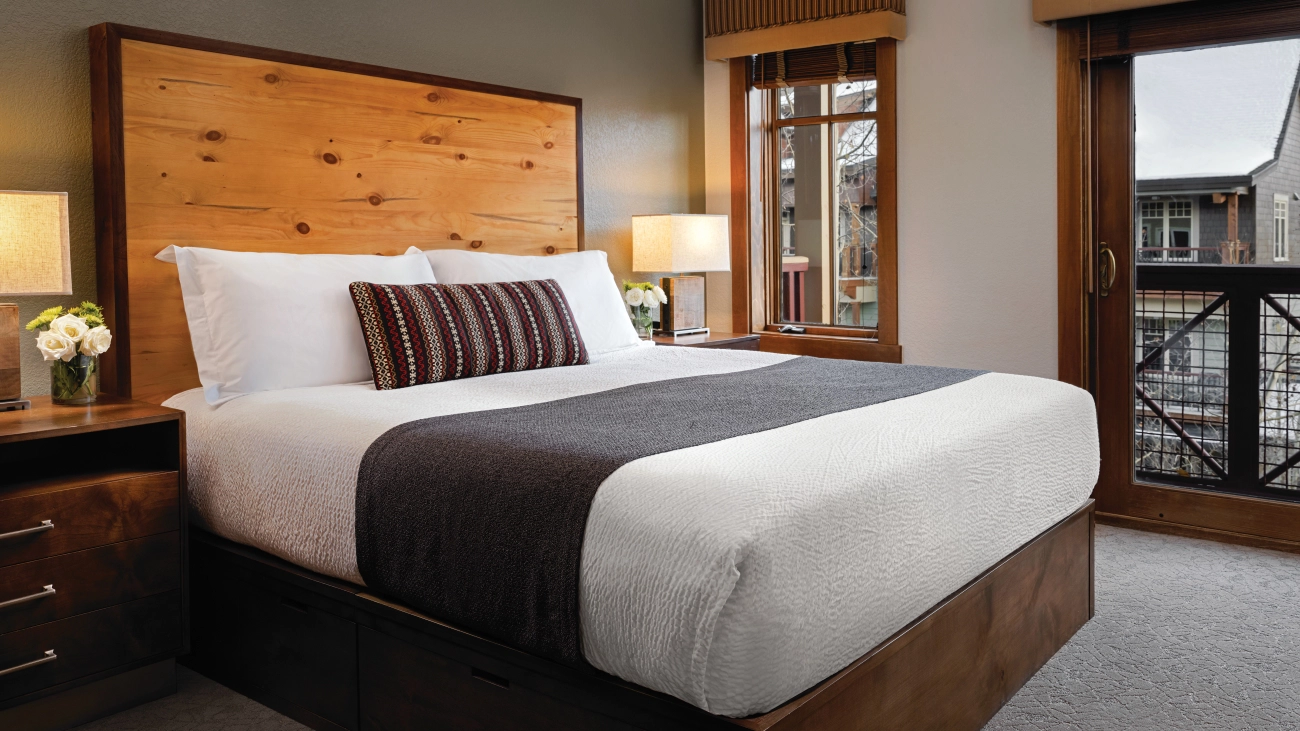 View of villa bedroom with rustic wooden headboard
