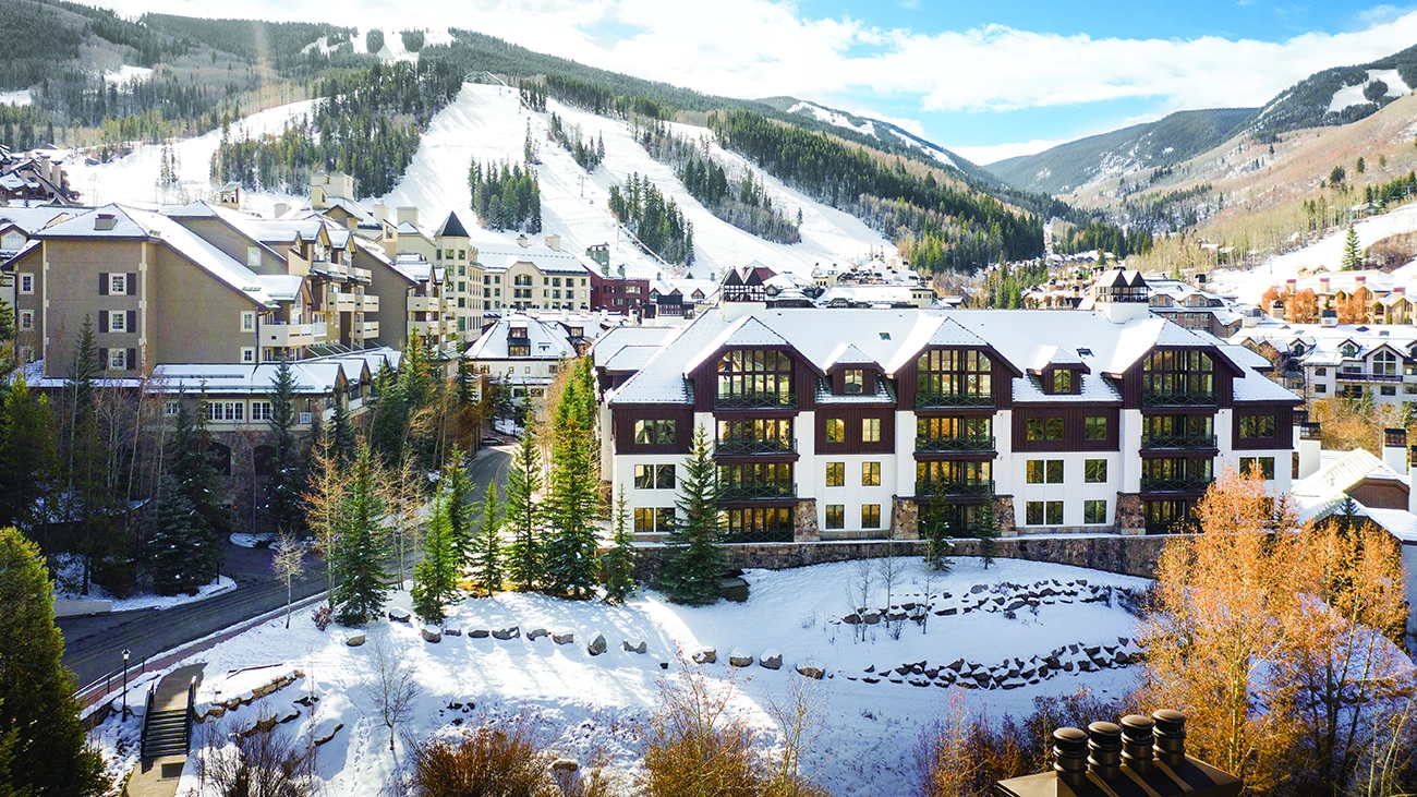 A snow-capped Beaver Creek Mountain Lodge sits beside a mountain in wintertime