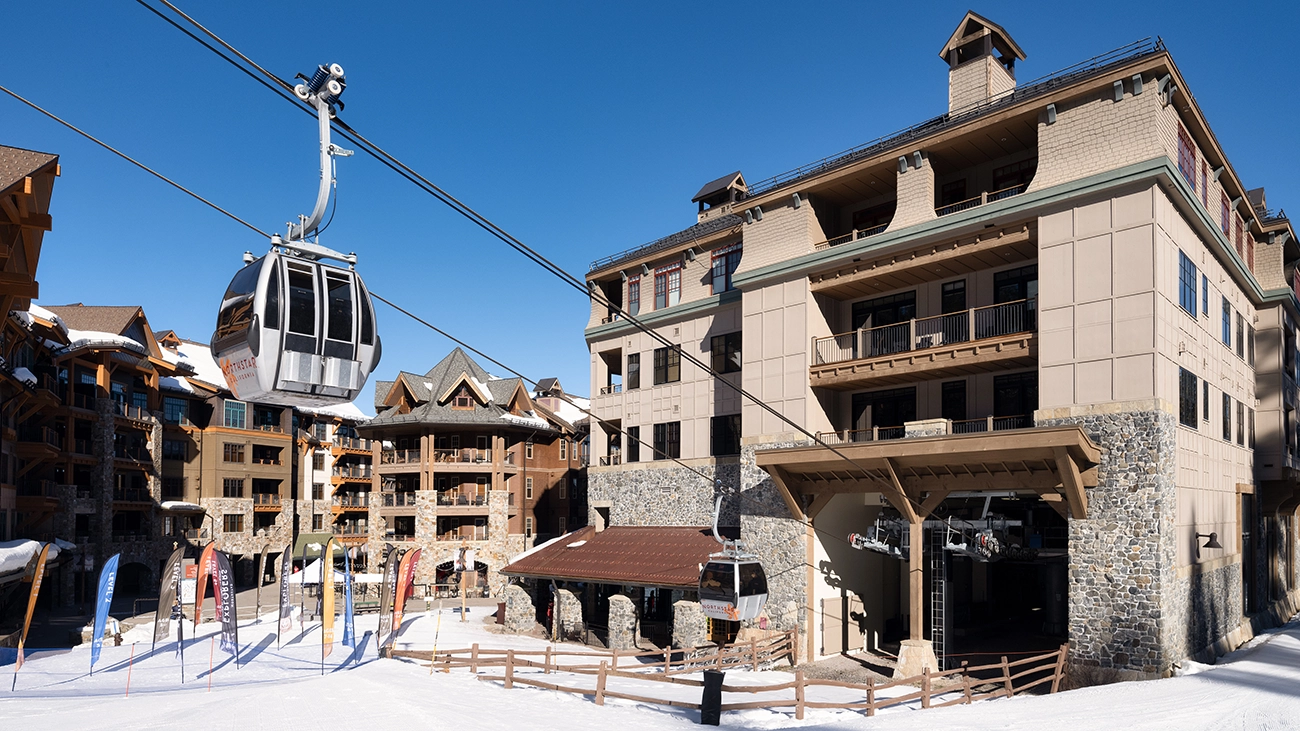 A chairlift exits One Village Place heading to the nearby mountain