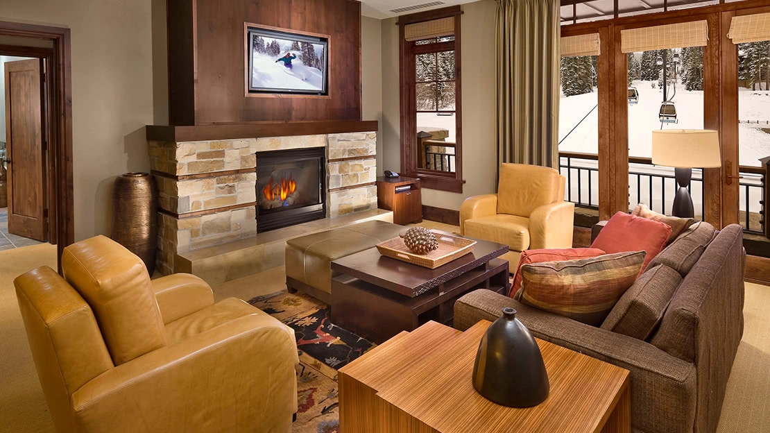 The living area of a villa features a flat screen and fireplace