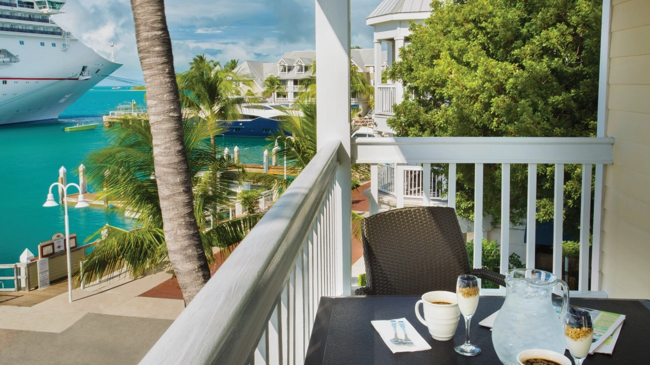 View of cruise ship in the aquamarine water from a resort patio