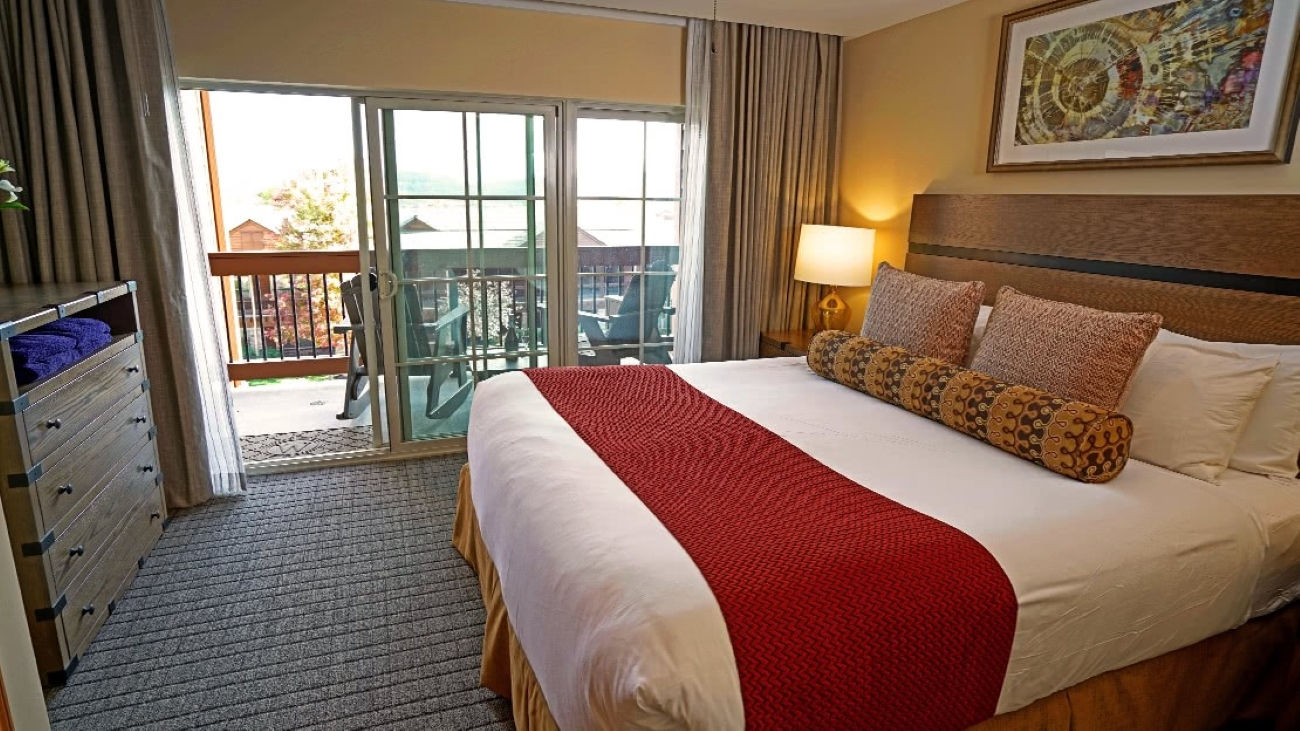 Bedroom with balcony and Adirondack chairs