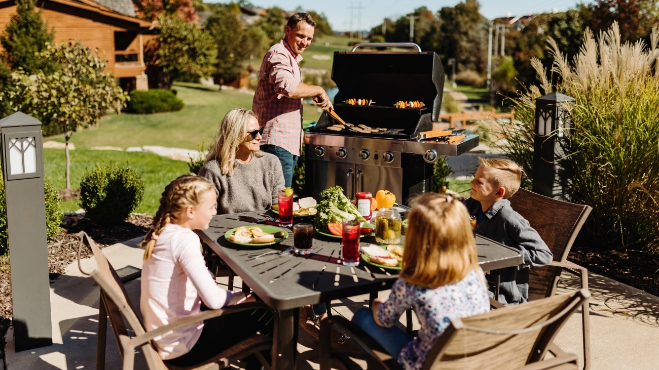 Family members at the grill and table